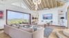 Bright living room at st barts villa rentals with ocean view, modern decor, vaulted ceiling, and soft neutral tones.