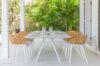 Outdoor dining table at st barts villa surrounded by lush tropical garden and natural light.