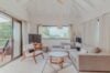 Contemporary living room at Villa Armancaya featuring soft neutral tones, wooden accents, and garden views in St Barts.”