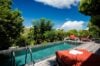 Private plunge pool surrounded by lush tropical greenery and red loungers at Villa Plumbago, st barts villa rental