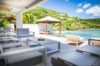 Modern open-air lounge facing infinity pool and green hillside at Villa Plumbago, st barts villa rental
