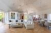 Spacious living and dining room at st barts villas with vaulted ceiling, contemporary art, and open-air design.