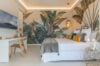 Tropical-themed bedroom in luxury st barts villa with botanical mural and soft natural light.