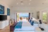 Bright ocean-view bedroom at luxury villas st barts with terrace access, modern decor, and calming coastal tones.