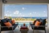 Terrace lounge with ocean views, black sofas and orange cushions at a luxury villa in St Barts