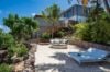 Private sandy terrace with sun loungers and palm trees below Villa Plumbago, st barts villa rental