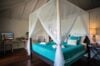 Bedroom with four-poster bed and turquoise linens at Villa Plumbago, st barts villa rental