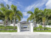 Grand villa entrance framed by palm trees and white walls at a luxury St Barths villa rental.