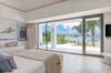 Bright bedroom with panoramic sea view and terrace access at a luxury St Barts villa rental.