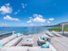 Expansive ocean-view terrace with modern lounge seating and sun loungers at a St Barts villa rental.