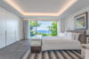 Spacious bedroom with ocean view and modern lighting design at luxury villa rental in St Barths