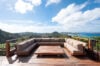 Outdoor lounge terrace at luxury st barts villa with panoramic island and ocean views.