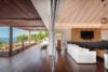 Open-plan living area and terrace at luxury st barts villa with ocean view and wooden design.