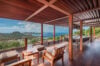 Covered wooden terrace at luxury st barts villa with lounge seating and panoramic Caribbean view