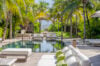 Palm-lined swimming pool and sun loungers leading to the beach at a luxury St Barts villa rental