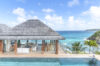 Infinity pool facing turquoise sea and open living pavilion at luxury villa rental in St Barthélemy.