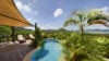 Tropical pool surrounded by palm trees with ocean view at Villa Plumbago, Colombier, vacation rentals St Barts.