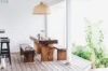 Outdoor dining area with wooden table and tropical greenery at private villa rental in St Barthélemy