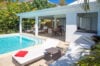 Sunlit pool terrace with loungers and shaded outdoor living area at Villa Plumbago, St Barts luxury villa rental